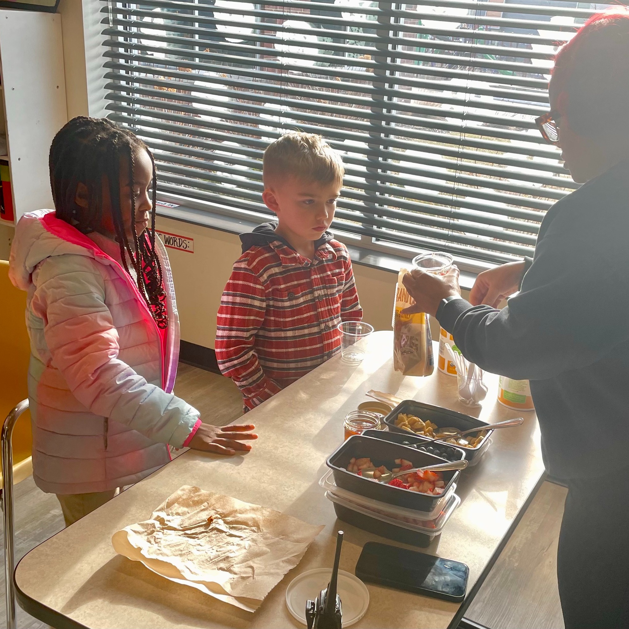 Here is Ms. Kajen taking an IMHC opportunity to teach the kids about a healthy snack, yogurt parfait, and the nutrition that the ingredients provide!