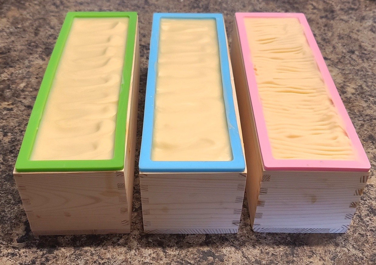 And 3 batches of tallow cold process soap made! I changed my mind a little bit on the scents, but we have Eucalyptus, Nag Champa (very earthy Sandalwood, Patchouli and floral scent) and Sweet Bourbon. No coloring, I wanted to keep these close to as basic and natural as I could aside from two of the fragrance.
Looking forward to cutting these and adding them to the curing rack tomorrow!