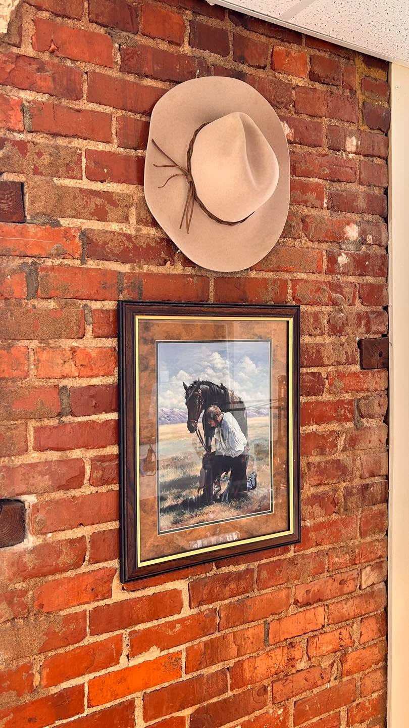 Another wall honors the late Steve Buchanan. This was one of his favorite hats that he almost wore daily, and a print that ties in a lot of his loves. They both hang in our studio along with his Bible, reading glasses, and his mic cover. Only thing missing is the ocean and a boat 🤗🛥️