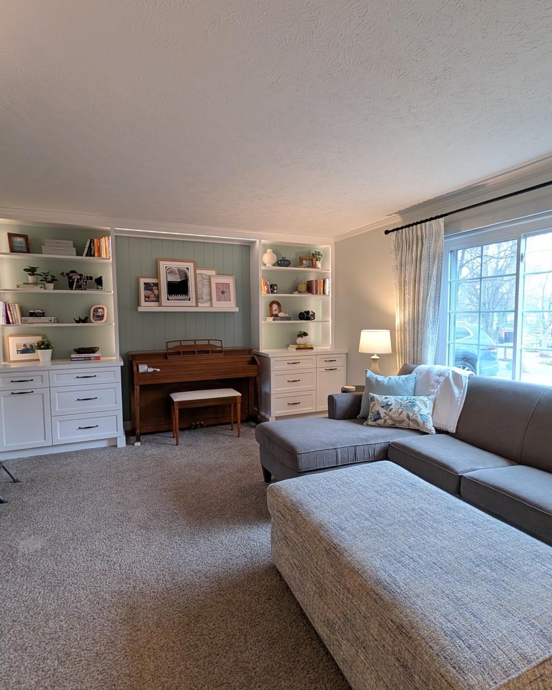 I am loving how this room has come together. I recently spent time working on accessorizing this new custom built-in I designed especially around this piano.
We added a vertical shiplap in an accent color to the wall to create the perfect backdrop for books, family photos and special pieces.
This built in adds personality, height, dimension and purpose to the room.
#interiordesigner #custombuiltin #customcabinets #verticalpaneling #livingroominspiration #uprightpiano #mentorohio #clevelandinteriordesign #homeremodeling #homeupgrades