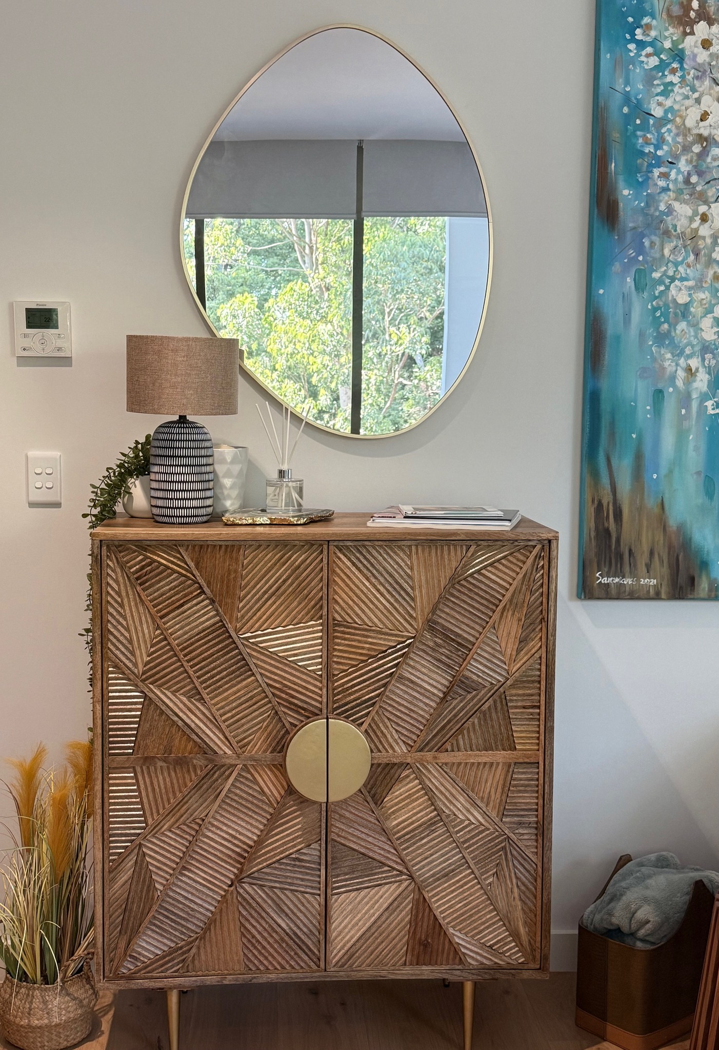 Layering a mirror with a bar cabinet is one of the easiest ways to create a space that feels both elevated and inviting. Start with your mirror, this is your statement piece. Whether it’s oversized, arched, or has a bold frame, position it just above or slightly overlapping the bar cabinet to create that seamless, layered look. If you want a more relaxed vibe, try leaning the mirror against the wall for an effortless, styled feel.
On the bar cabinet, think curated, not cluttered. A sculptural tray, a stack of books, or a small lamp can instantly add depth and personality. Balance is everything. If your mirror is bold, keep the styling below more minimal. If the mirror is simple, you can have a bit more fun with textures and shapes on the cabinet.
Finish it off with something organic, fresh flowers or greenery to soften the look and bring life to the space.
#HomeStyling #ditaylorinteriors