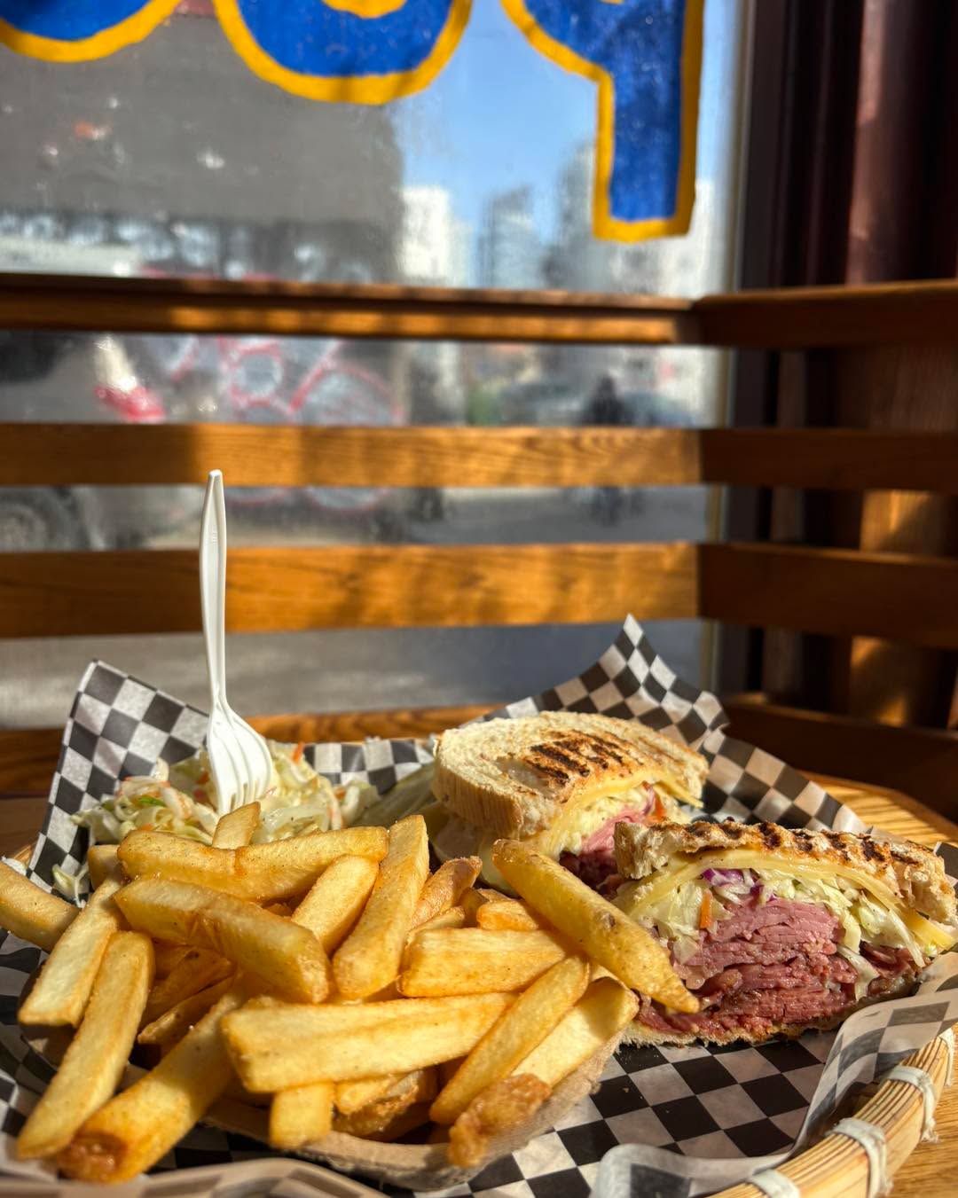 Brooklyn Rueben and a side of fries in the window table 👌