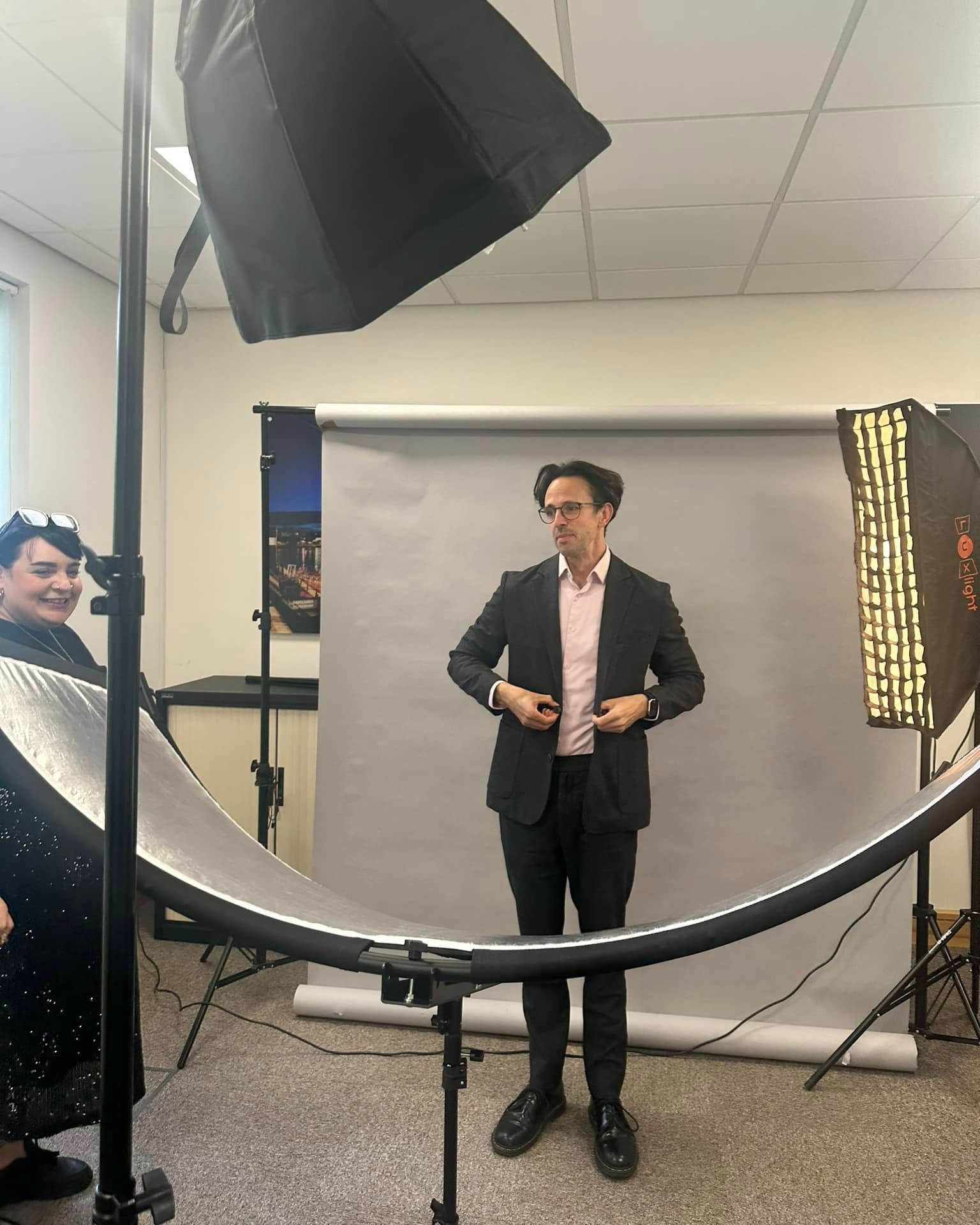 What you see: a man in an office with a backdrop and some lights.
What I see: a polished, professional headshot waiting to happen.
This is why the behind the scenes never looks like the final result.
Most people are looking at the room.
I am looking at the light, the angles, the expression, the posture, the jacket, the glasses, the background, and all the little adjustments that make the final image work.
It does not need a fancy location.
It just needs someone who knows what they are doing.