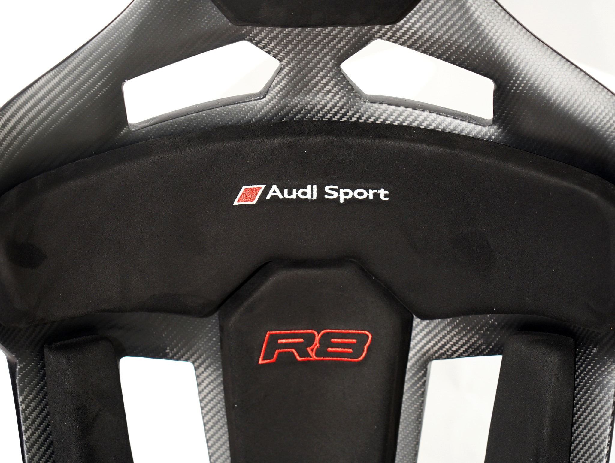 Matt CF Seats GT-Max with custom padding for Audi R8.
- Debossed Audi logo on headrest padding.
- Audi Sport and R8 logo stitching at backrest padding.
- Double thickness padding.