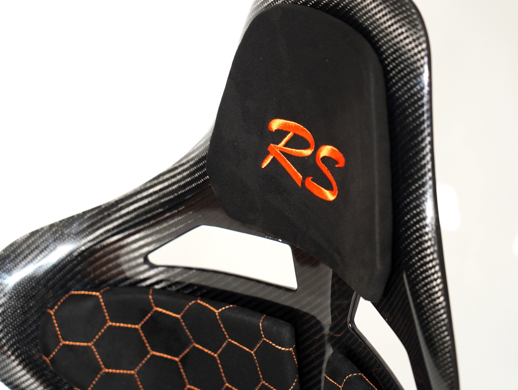 CF Seats V5 with black Alcantara padding and orange honeycomb stitching pattern + orange Audi RS logo on headrest padding.