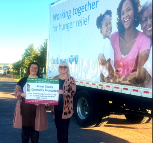 The Adams County Community Foundation (ACCF) recently awarded a grant to Community Harvest Food Bank for Adams County Farm Wagon Program. The Farm Wagon Program makes weekly stops in Adams County to distribute fresh produce, dairy products, and other healthy foods directly to families in need with a drive-through distribution. In Adams County, the Farm Wagon distributes food on Wednesdays at 9:00am at the Don Ray Memorial Park (115 Memorial Dr., Monroe, IN). The Farm Wagon distributions generally last about one hour and is on a first come, first serve basis.
Nehemiah Godsey, Community Harvest Food Bank grant writer, expressed appreciation to the ACCF for this support which has provided 206,586 pounds of food to Adams County families in need in 2024. Louise Ray, ACCF board president and grants committee member noted that the ACCF is pleased to be able to support Community Harvest Food Bank and their efforts to provide food to families in our community.
This ACCF grant was made possible through unrestricted fund sponsored by the John & Kay Boch Fund. John Boch was the Decatur postmaster and Kay Boch was the owner of the popular ‘Kiddie Shop’ on Second Street in Decatur. Though deceased, they are leaders in the philanthropic giving in Adams County. Establishing a supporting organization in the ACCF in 1996, this fund has provided stability to the Foundation. Growing the fund to over $5,000,000, nephew Robert Boch was very dutiful as he managed the investment and the distribution of the grants and scholarships.