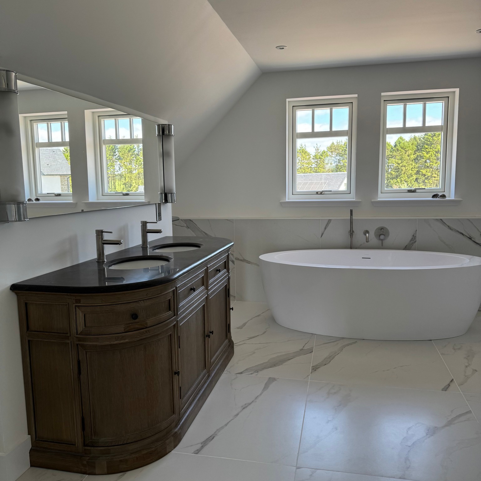 A stunning master ensuite👌
Carrara marble tiles, creating a clean, high-end feel throughout.
Client chose a freestanding bath for that luxury touch, double sink unit and a spacious walk-in shower — all brought together with quality fittings from @lussostone @tikamoon @CTD Architectural Tiles and @oceanairperth
Another project we’re proud to hand over.
#BathroomDesign #EnsuiteInspo #CarraraMarble #LuxuryBathroom #HomeRenovation #NewBuild #Extensions #ConstructionLife #Renewables #PlumbingAndHeating #ScottishHomes #WalkInShower #FreestandingBath