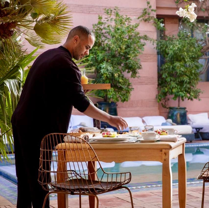 Mornings at Dar Rhizlane begin slowly, exactly as they should.
Set on a sunlit terrace or tucked within the garden, breakfast unfolds with simple, generous pleasures, fresh breads, pastries, seasonal fruits, and juices that taste like Marrakech itself .
Nothing feels rushed, everything invites you to linger a little longer, to take your time between each sip and each bite.
It’s not just breakfast, it’s a moment of stillness before the day begins, where light, flavors, and quiet surroundings come together effortlessly.
#DarRhizlane #MarrakechMorning #breakfastmoment #luxurytravel #moroccotravel