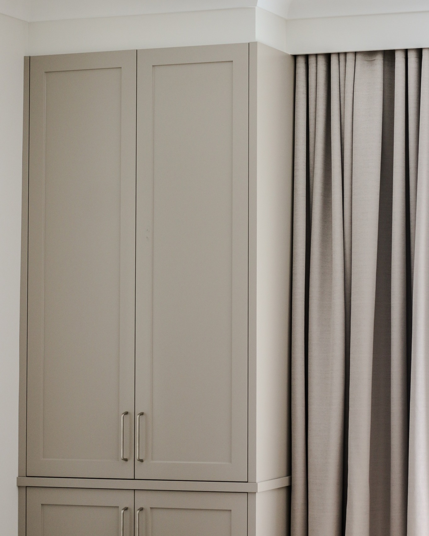 Elegant built-in joinery in the living area boasts a timeless, classical aesthetic. Featuring a Shaker profile, slimline handles, an upholstered bench seat, and built-in curtains, this space is perfectly designed for relaxation and enjoyment.