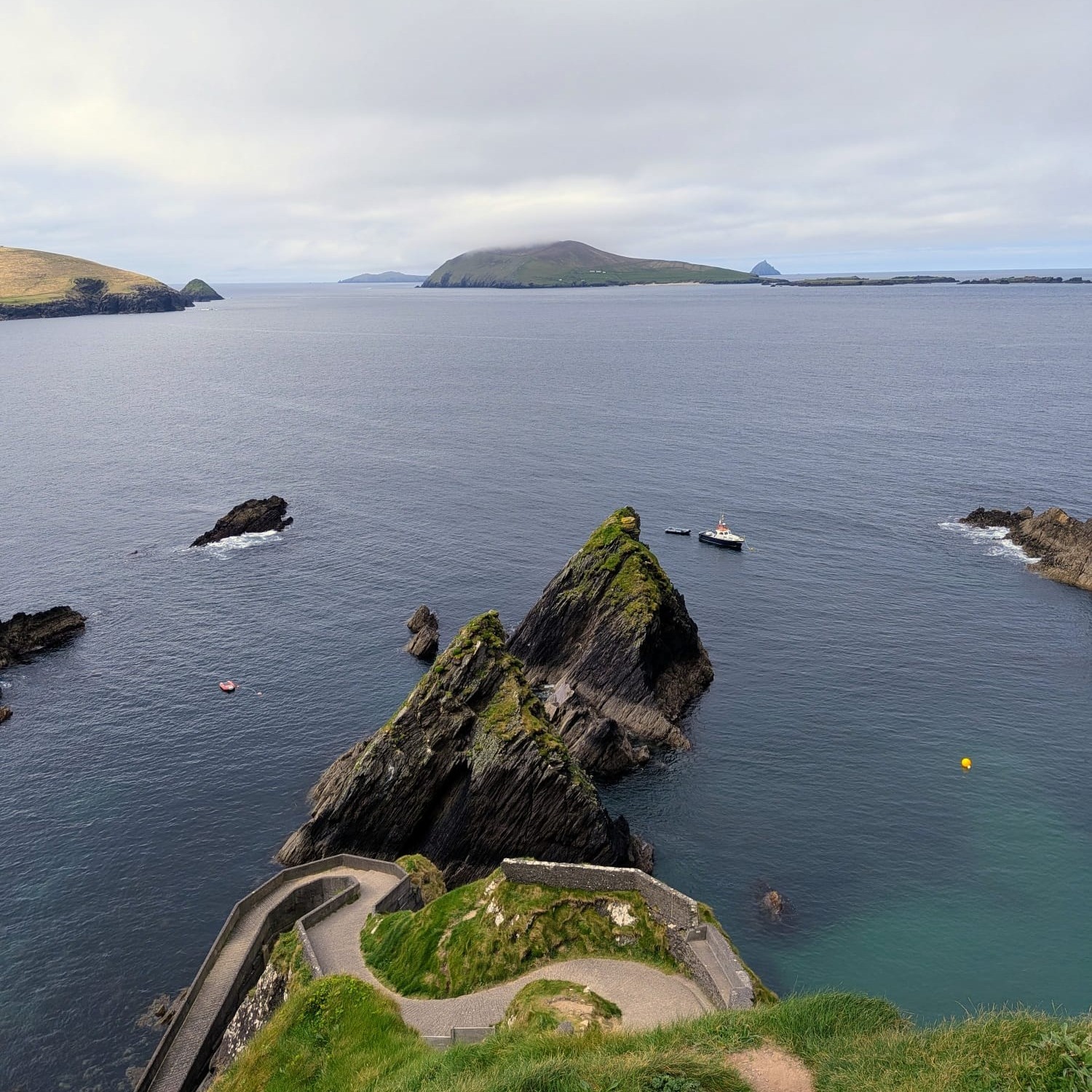 What did it take to survive on the edge of Europe? 🌊☘️
Dunquin Pier was never built for the view; it was built for survival. For centuries, this narrow slipway was the only lifeline for the people of the Great Blasket Island.
It was the departure point for the traditional currachs, hand-built wooden boats covered in tarred canvas, that the islanders used to navigate the treacherous Blasket Sound. Its steep, winding design, often called the "Sheep Highway," was a necessity of geography, allowing the community to haul livestock, supplies, and these lightweight boats up the jagged cliffs of the Dingle Peninsula.
The pier was the stage for both the arrivals and the final departures of a vanishing way of life. It was through this rugged gap that the mail arrived, and where, in 1953, the last remaining islanders finally stepped ashore to settle on the mainland, leaving their ancestral homes to the wind and the sea.
If you want to dive deeper into this history, we highly recommend visiting the BlasketCentre (Ionad an Bhlascaoid) nearby before walking down to the pier. It provides the perfect context to truly understand the stories of the people who landed here.
In Ireland @thewildatlanticway