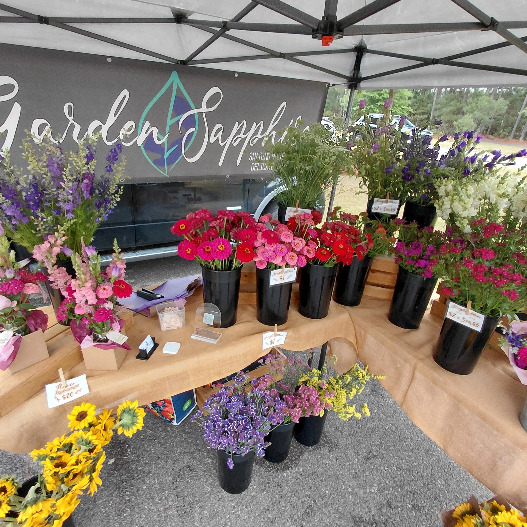 Garden Sapphire is out on this Rainy Friday with arm fulls of flowers!
We are at the Second Entrance to Sanctuary Cove at Copper Lane until 7pm tonight.
The Cane Bay Farmers' Market has been delayed until next Saturday, so we will not see you Saturday. BUT....we will be at Eggs Up Grill Sunday morning!!
We look forward to seeing you!