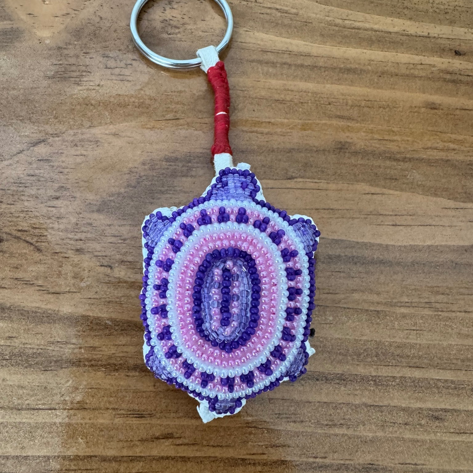 Traditional Lakota umbilical cord amulets, referred to as čhekpá ognáke or navel containers, are intricately crafted, often beaded, leather pouches that house a newborn's dried umbilical cord, thereby ensuring a long and protected life, while fostering a profound connection to their mother and the natural world. These amulets, typically shaped as turtles for girls, symbolizing longevity, or lizards for boys, representing survival, are attached to cradleboards to safeguard infants from malevolent spirits and harm. The amulets, frequently fashioned from buffalo hide and adorned with intricate beadwork, are considered a baby's inaugural toy and a sacred talisman. The Lakota people deliberately select turtles (Keya) for girls, acknowledging their remarkable longevity, and lizards (Agleska) for boys, recognizing their remarkable survival abilities.