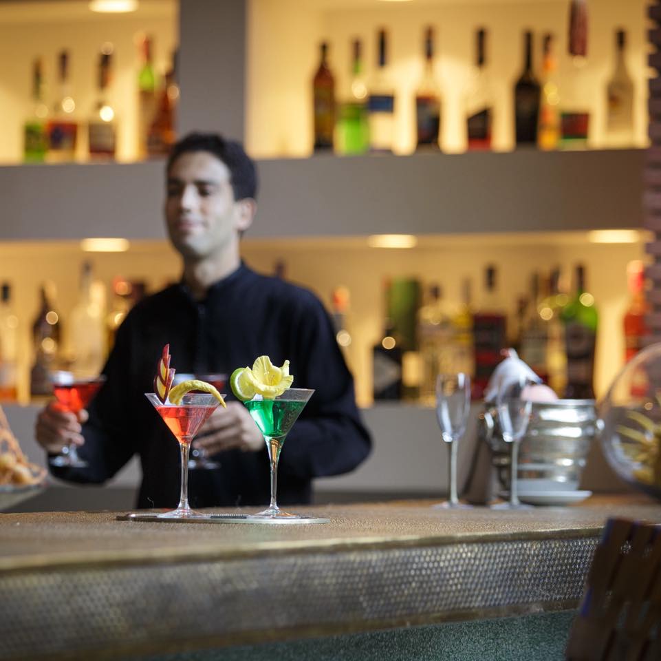 Evenings begin at the bar.
A quiet ritual of movement and precision, where colors, aromas, and textures come together in a single moment. Each cocktail is not just prepared, but composed balancing freshness, detail, and intention.
Behind the counter, gestures are fluid and effortless. In front of it, time slows down. Conversations soften, light warms the space, and the atmosphere shifts into something more intimate.
This is not just a drink. It’s the beginning of the night.
#RiadNights #marrakechexperience #cocktailtime #luxurymoments #eveningritual #moroccanhospitality #baratmosphere