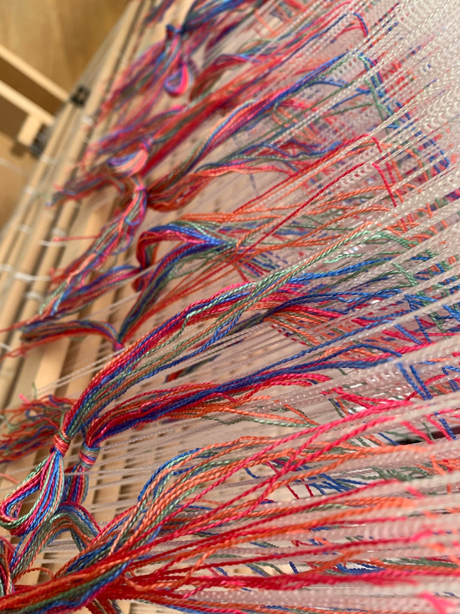 Four colours in echo weave, slowly finding their rhythm in fine silk.
As the shuttle flies, the cloth shimmers and shifts — turquoise becoming violet, coral dissolving into rose — every thread catching the light a little differently.
This scarf began long before it reached the loom:
in skeins of silk hand-dyed in five luminous colours,
in the careful winding of the warp,
the quiet threading of heddles,
and the steady music of weaving itself.
Today I hope to cut it from the loom, wet finish it, and hand twist the fringes — the final gentle rituals before the silk truly comes alive.
There is something deeply satisfying in every stage of this process.
Slow cloth. Slow colour. Slow art.
#surreyartistsopenstudios #farnhamcrafttown #textileart #slowcraft