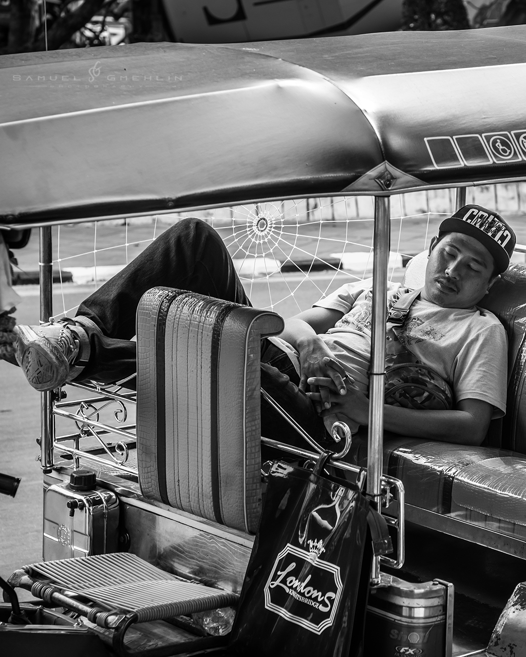 A Nap Inside the Chaos
•
Most people remember Bangkok for the traffic, noise, and endless movement, but moments like this always stayed with me more. Right in the middle of the chaos, this tuk tuk driver had found a way to completely disconnect for a few minutes and turn his vehicle into a tiny resting place. I liked the contrast between the energy people usually associate with the city and the calmness of this scene. Sometimes street photography is simply about noticing the quieter moments others walk past. 🛺🖤
•
Swipe ➡️ for the print version!
•
@nikonasia #nikond750 AF-S 24-70mm f/2.8 ED VR
•
ISO 400 | f/6.3 | 1/30s
•
•
#streetmoments #lensculturestreets #atlasofhumanity #humanity_shots #people_and_world #world_portraits #blackandwhitepics #bnwmood #natgeo_humanity #streets_storytelling