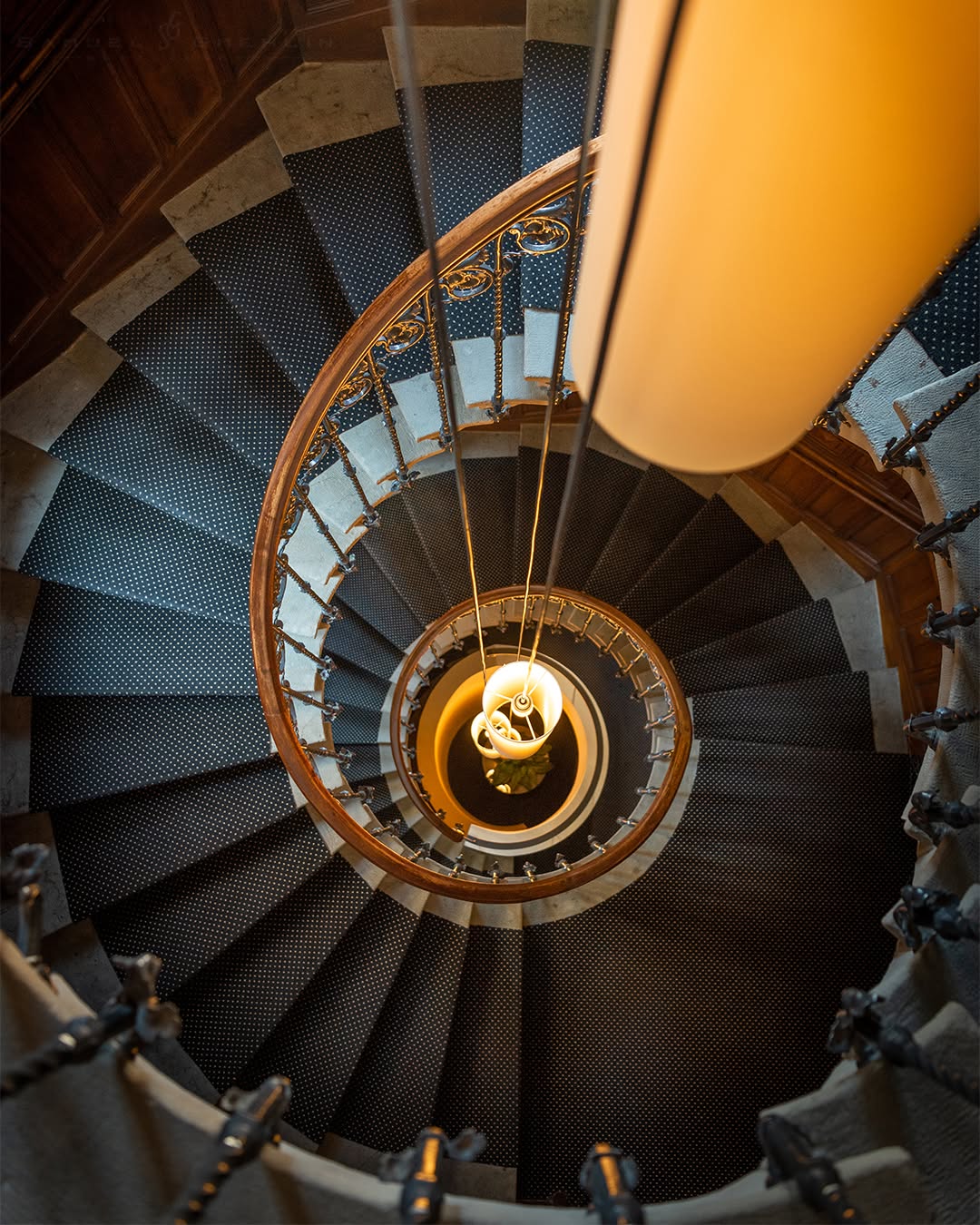 Enchanted Dungeon
•
I’ve always had a weakness for staircases, especially when they reveal themselves from an unexpected angle. Looking down into this spiral felt almost hypnotic, with every step, railing, and curve naturally guiding the eye toward the center. What I liked most was the contrast between the dark repeating geometry and the warm light glowing below. The longer I looked, the more the staircase stopped feeling like architecture and started feeling like an abstract work of art. 🌀✨
•
Swipe ➡️ for the print version!
•
@nikoneurope #nikond750 AF-S 14-24mm f/2.8 ED VR
•
ISO 640 | f/2.8 | 1/40s
•
#architectureporn #architecturelover #geometry #geometrygrammer #architecturedesign #architecturedaily #architecture_hunter #staircase #staircasedesign #staircasefriday #staircaseporn #spiralstaircase