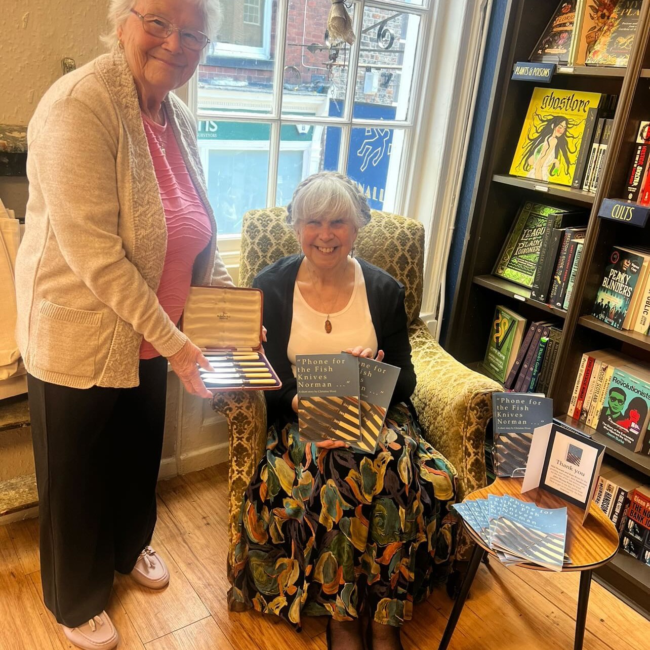 Yesterday was exciting, fun and very satisfying. A while ago I wrote a short story entitled Phone For the Fish Knives Norman, a quotation from a John Betjeman poem. I thought it might be made into a fundraising booklet for IDAS (Independent Domestic Abuse Services), the charity supported by Criminally Good Books in York. Isla, the bookshop owner, loved the idea but first we needed permission to use the quotation as it was still in copyright. This was very kindly given by John Murray Press so we were able to go ahead.
Generous assistance was given by Kate Went who did the layout and designed the cover, Ann Sanderson, who lent her fish knives for the cover photo, and Mat Dowsett who did all the printing.
It all seemed to take forever but, finally, there we were at the shop for photos with Isla, and signing before the copies went on sale. A lot of effort, yes, but for a very worthy cause.
The title comes from Betjeman's poem How To Get On In Society
@criminallygoodbooksyork @idasfor100 @johnmurrays @where_kate_went
