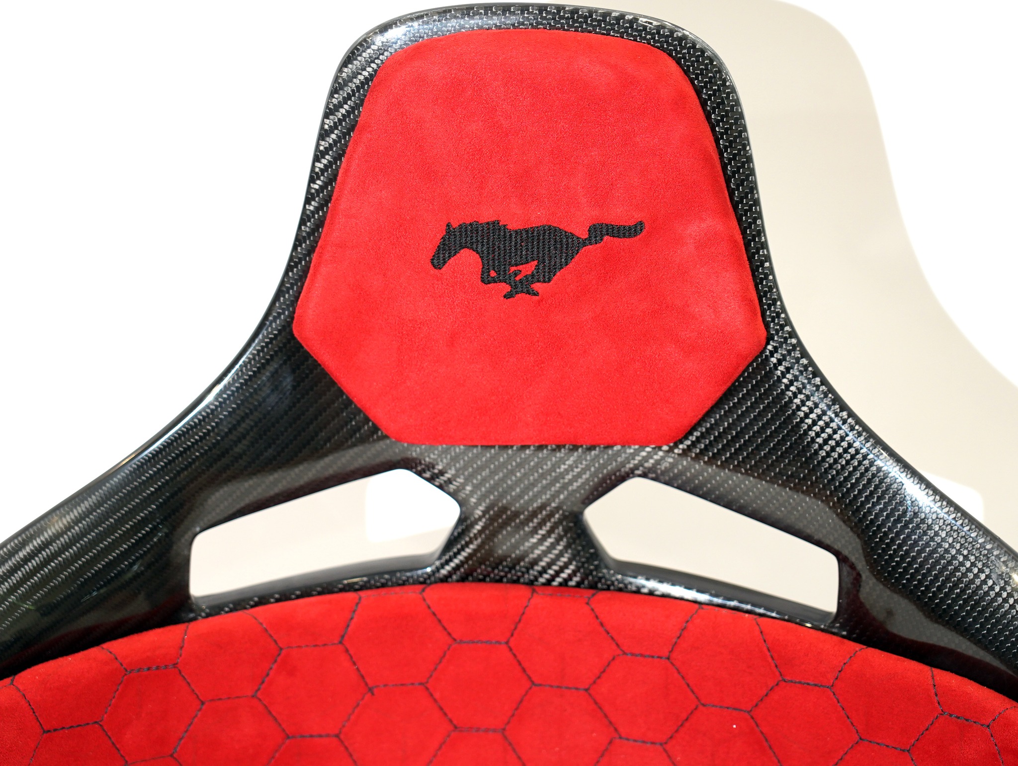 KevMannz GT-Max, full carbon fiber bucket seats, featuring vibrant red Alcantara padding, bold Mustang logo embroidery, and intricate honeycomb stitching - where performance meets limitless possibility! 💪