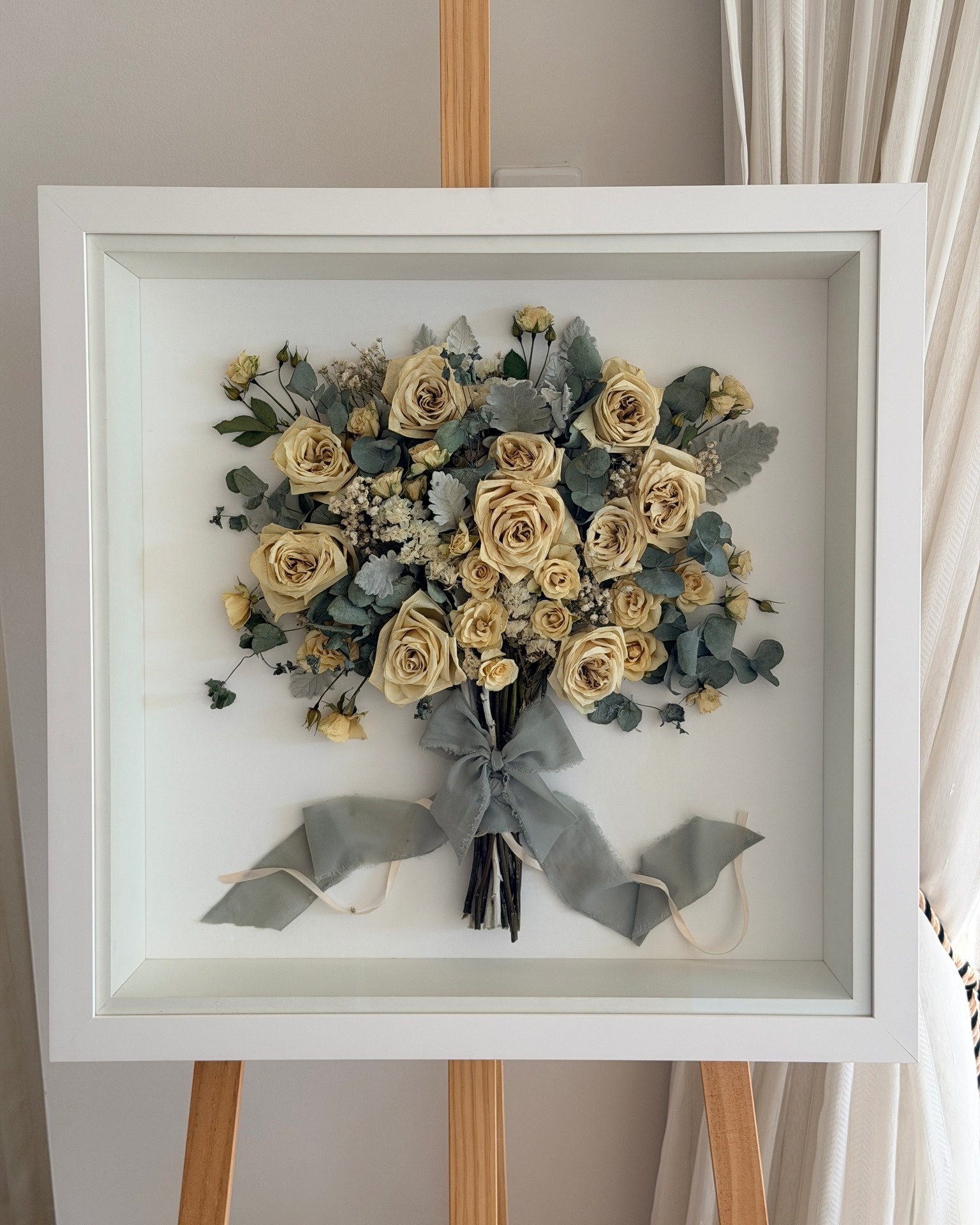 Cream roses, baby's breath, dusty miller and eucalyptus, all wrapped with a beautiful sage silk ribbon that tied the whole palette together.
White bouquets can be tricky to preserve. Without bold colour to anchor them, they sometimes lose their impact once they're framed. But Madi's had exactly what a white palette needs to sing — the silvery leaves of dusty miller, the soft greens of eucalyptus, and that gorgeous sage silk ribbon all working together to give the piece depth and quiet elegance.
#weddingbouquetpreservation #goldcoastbrides #goldcoastflowerpreservation #weddingkeepsake #cherishedblooms