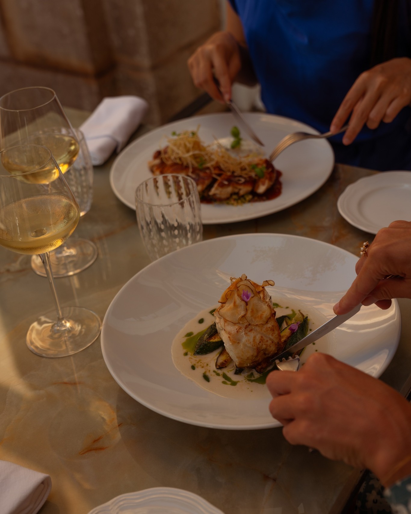 Dinner at the Palazzo, plates arriving almost too pretty to disturb, a glass of something white and cold beside them. Conversation slows down to match the pace of the meal.
Book your table - link in bio.