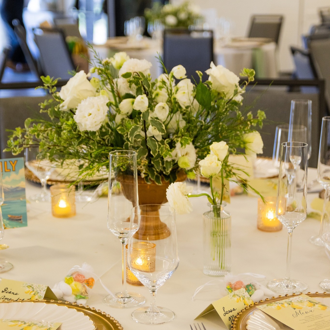 A softly lit table layered with fresh blooms, candlelight, and considered details for an effortlessly elegant celebratio