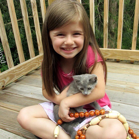 Naomi was getting a lot of attention while we took pictures of her and the rosary! This is our cat Milkshake. : -)