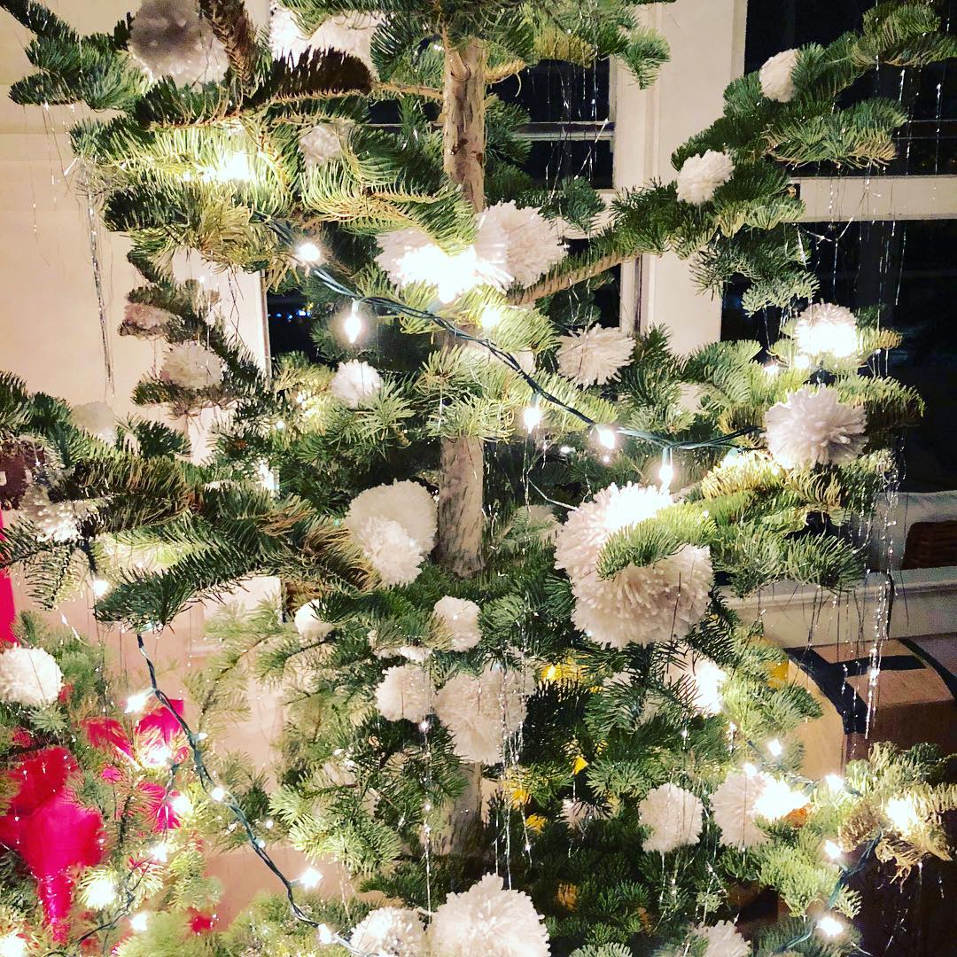 This poor tree was purchased half brown... so we fixed it up! The pom poms stick really well on the dry branches! ๐ #twasthenightbeforexmaseve