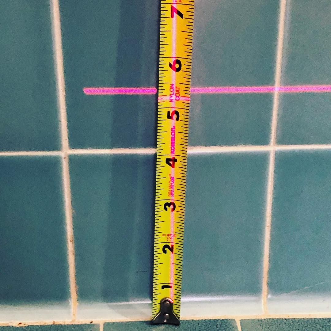 Laser level measuring exact difference in floor height. 3” slope within 10’. Major sloping due to hillside property, soil erosion, failing retaining wall and water in the crawl space.