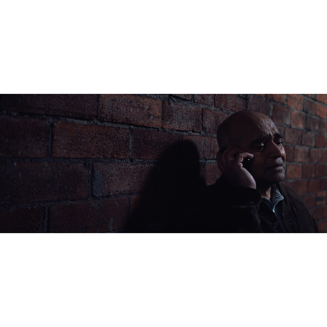 This was shot using purely available light coming from a small security light fixture on camera right. 
We were short on time so I opted to simply diffuse the security light, and make use of the quick fall-off to give the necessary depth💡