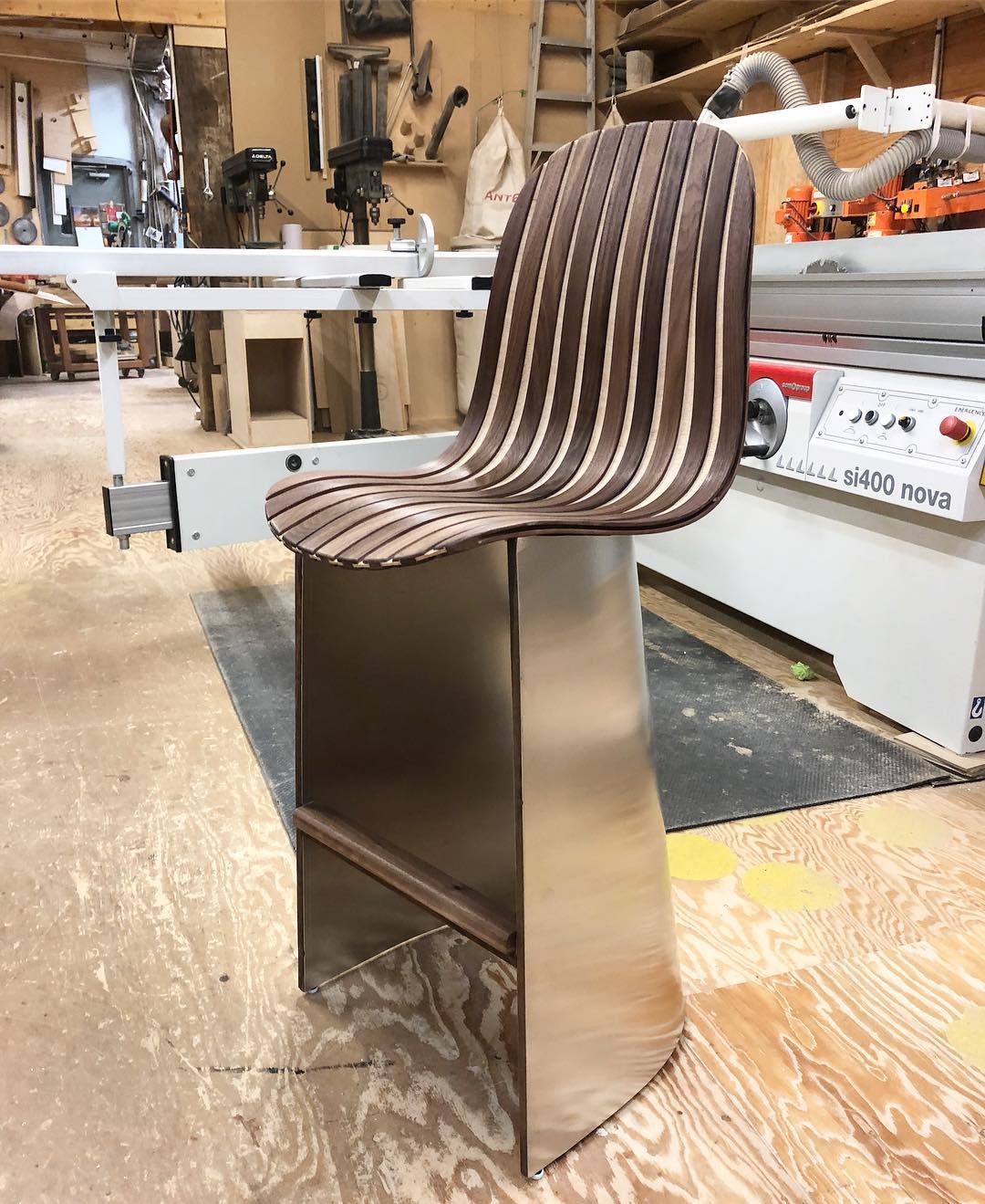 The archetype redesigned for a special client. These are counter height chairs made from black walnut and aluminum.