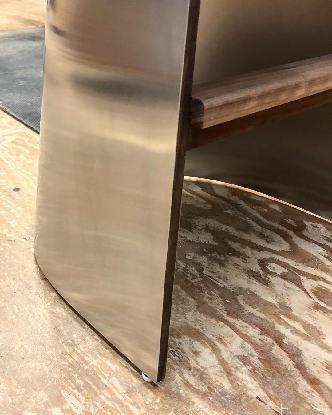 Shadowy metallic surface with black walnut trim detail.