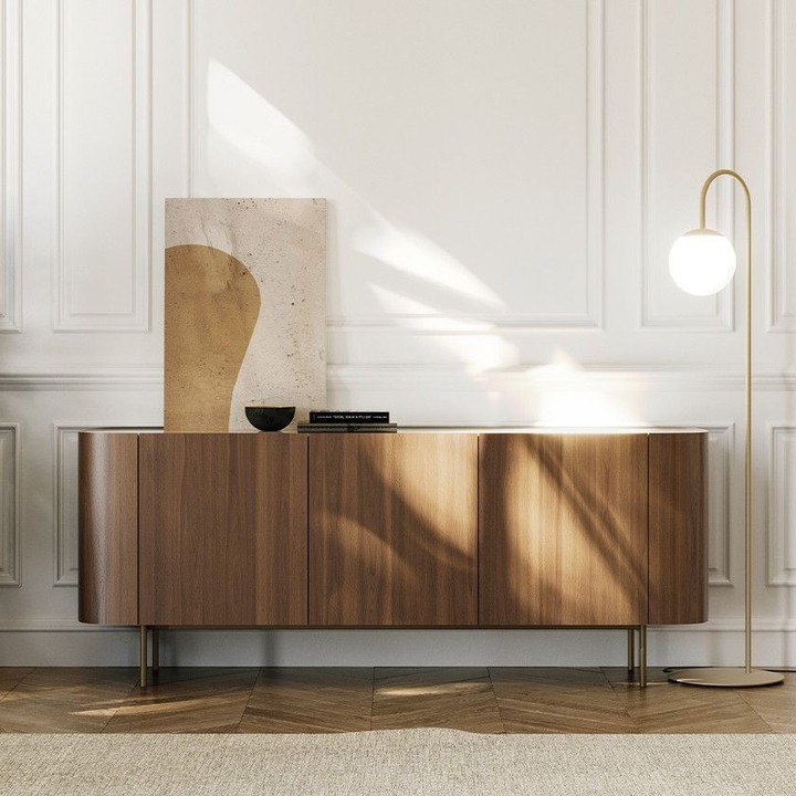 Introducing Syra, the epitome of elegance crafted by designer Ollen Pal. With its graceful curves, this three-door sideboard epitomizes exquisite craftsmanship. Handcrafted with a veneered wood structure and a bronze lacquered upper edge, it stands on four painted metal feet finished in bronze. The interior features comfortable smoked glass shelves, with the option of a glass or ceramic shelf.
#home
#interiordesignideas
#interiordesignlovers
#interiordesigninspo
#furnituredesign
#Console
#ElegantDesign
#Timelessfurniture
#Transformingspaces