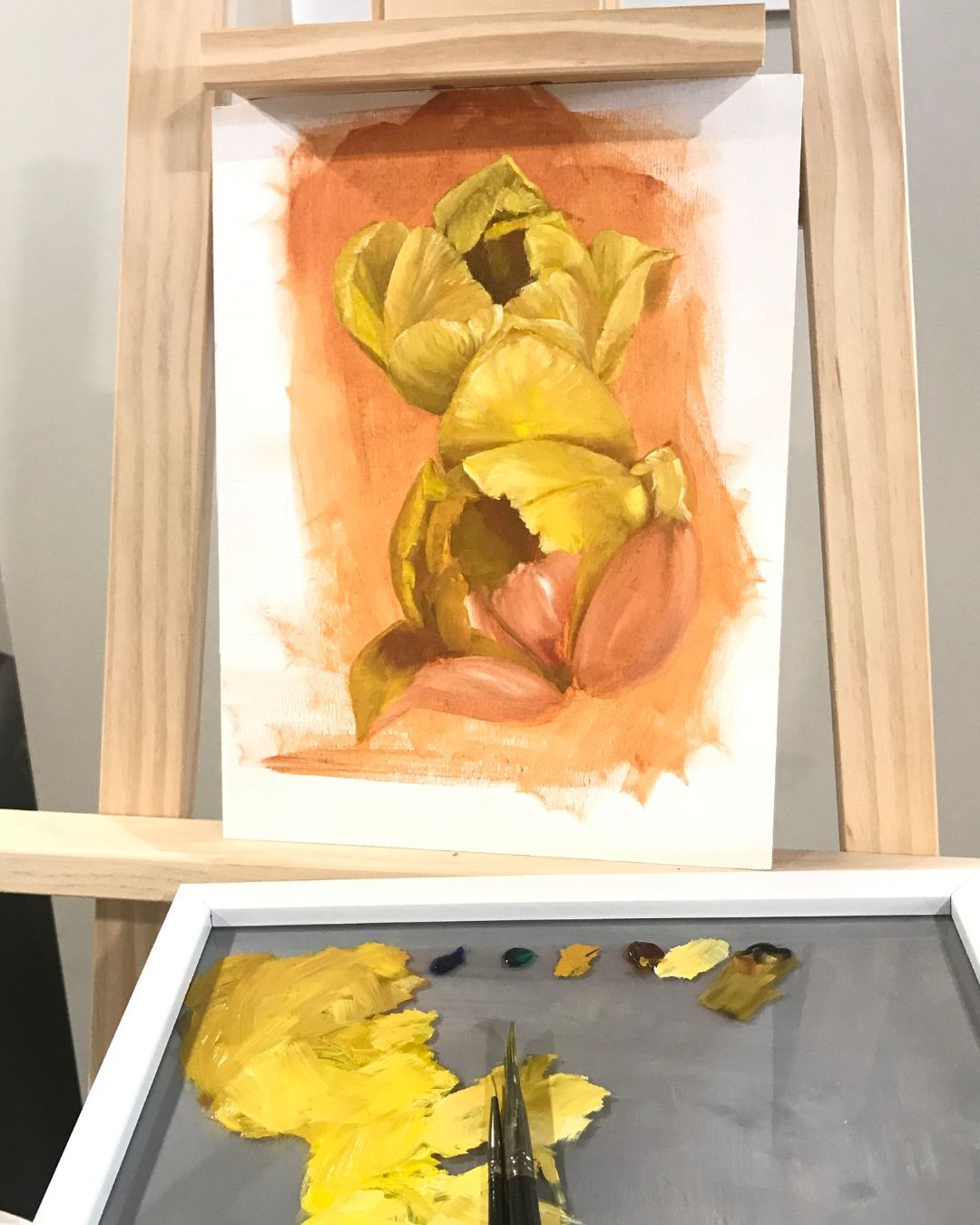 Work in Progress: I'm back to painting flowers in oil! Building the foundation of a yellow tulip by layering Burnt Sienna and Titanium White to create depth and texture. Swipe left to see the process.