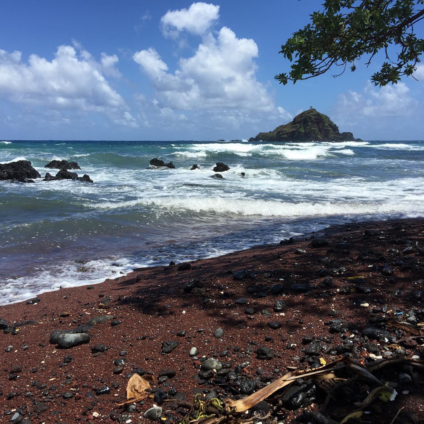 A red sand beach on the Road to Hana. It’s not the famous red sand beach, but that one is dangerous enough that our tour wouldn’t go to it, so we visited this one instead so we could still see the red sand. Maui is one of the only areas in the world that has red sand like this. #maui #hawaii #neunersnextadventure #travel #travelhawaii #travelmaui #roadtohana