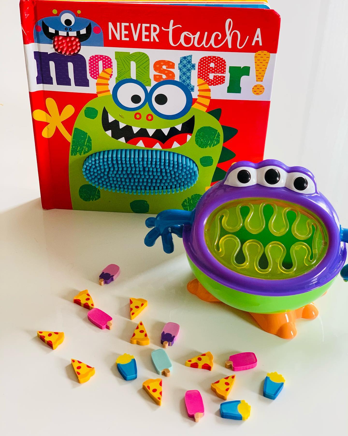 Happy Fall Y’all! 🍁 One of my favorite holidays is just around the corner! 
Any guesses? 🎃 
Themed activities are always a winner in therapy! I like to use an engaging and relevant book and something the child can manipulate while working on their speech and language goals. Here I pair a fun tactile book with a little monster snack cup and food erasers. My client had to produce a target word, in this case “eat” 5 times before feeding the monster a food of choice! 🍕 🍦 🍟 
We ended up getting lots of repetitions in! 
🔑 to motor learning and generalization. 
This could work through teletherapy too, the child would have to use his expressive language skills to instruct the clinician what to feed the monster. And don’t forget the fun monster sounds! Rawr!