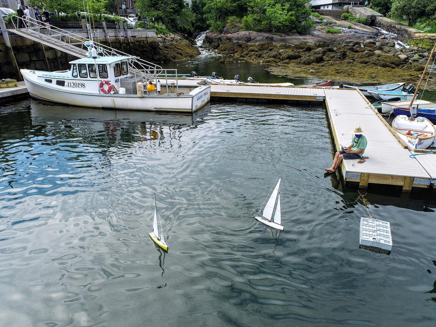 Model Yacht sailing in Camden Harbor. Watch their regatta Wednesday, October 14th @ 5PM!! 🌬⛵️☀️ #yachting #lobsterboat #camden #dragonforce65 #waterfall #maine #rc #dji #phantom4pro #uav