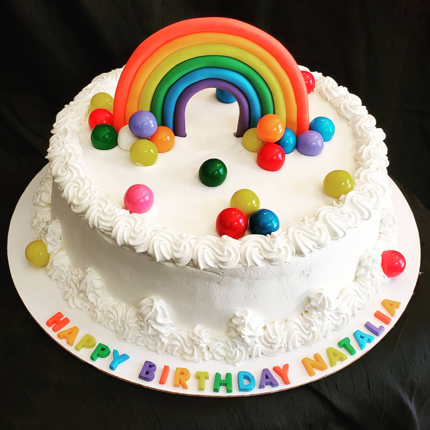 Fantastical marble rainbow cake filled with nutella and strawberries in between two layers of cake. Decorated by a magic clown, this cake never fails to hit the spot