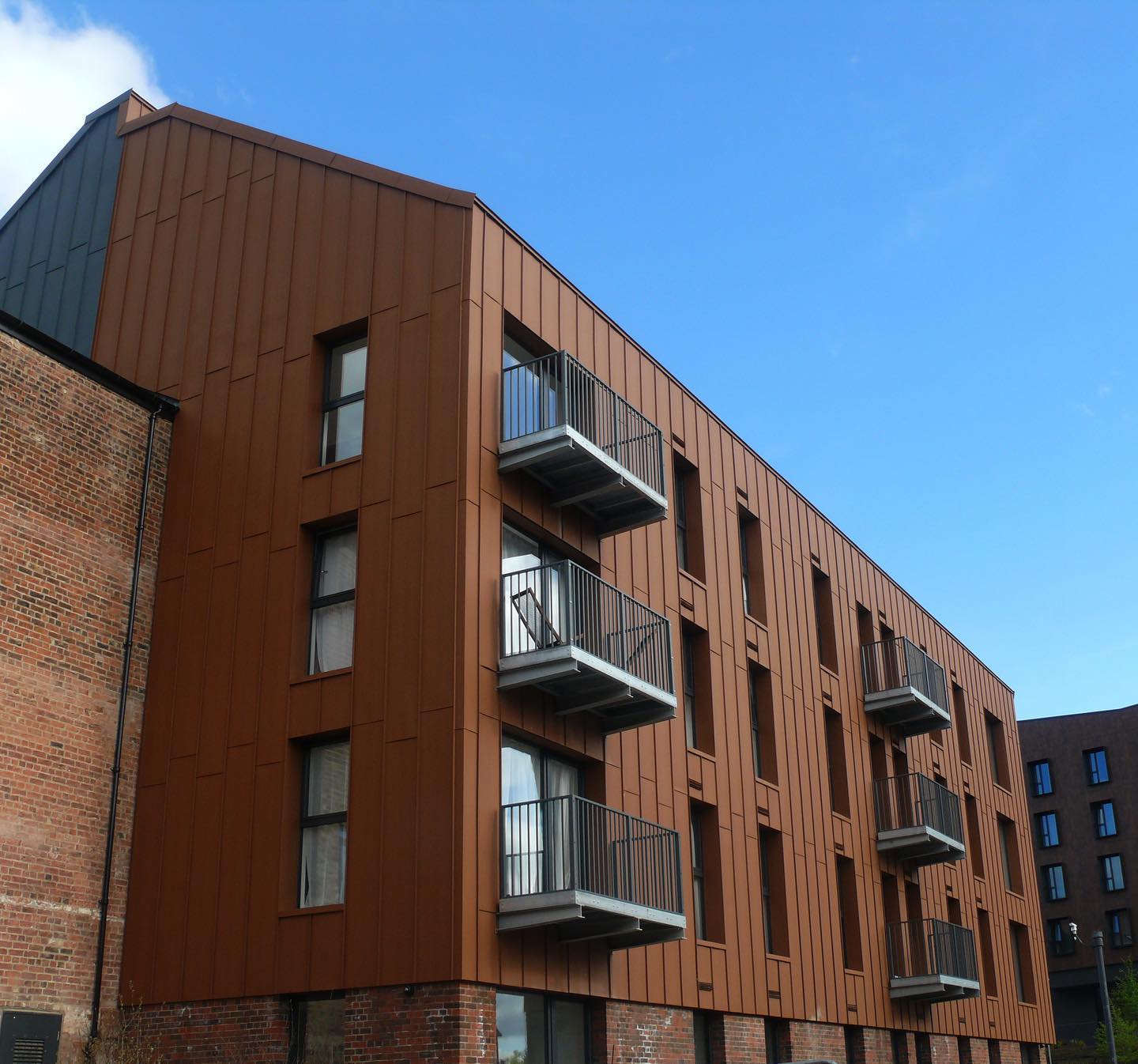 This eye catching project is The Shot Tower, Chester.
Shot Tower is made up of Traditional textures Coreten (orange) & RAL 7011 (grey) aluminium standing seam cladding , complete with an A1 non combustible build up.