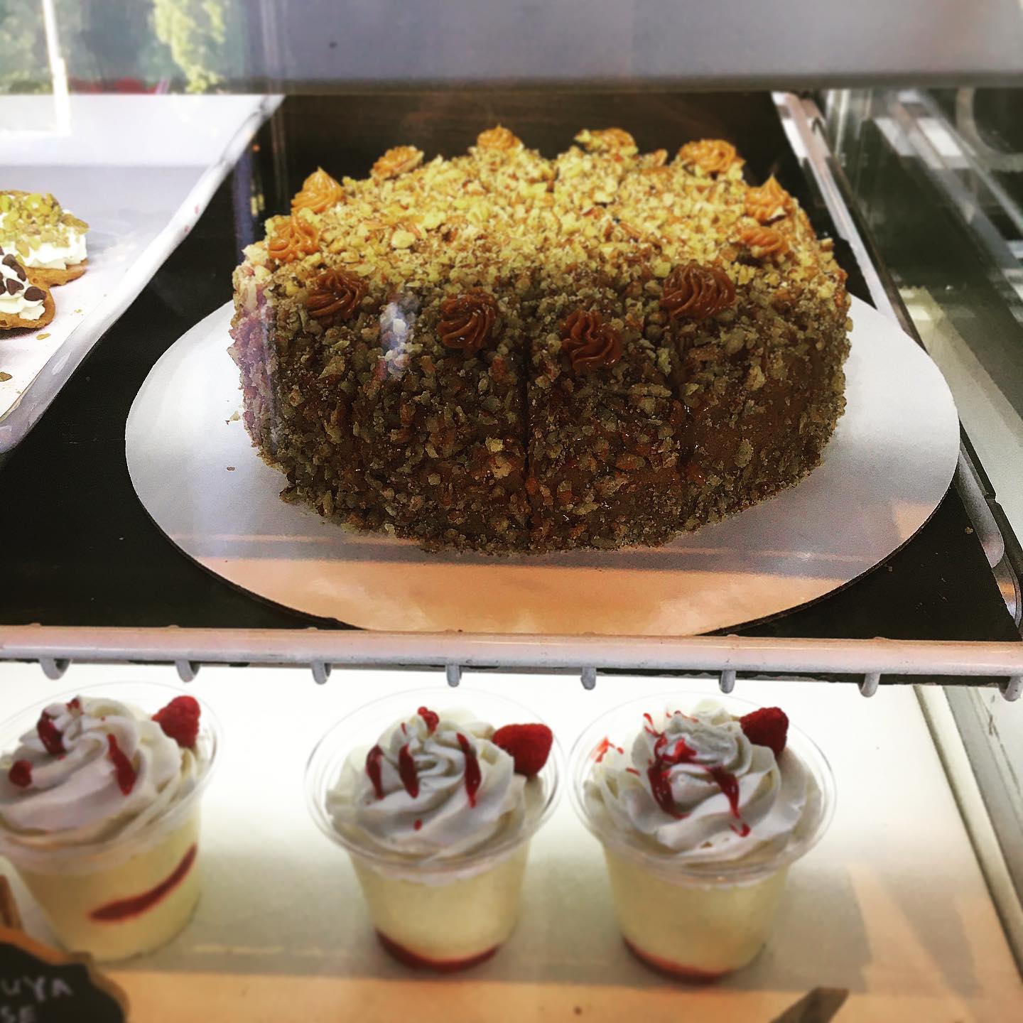 Here we have our signature Mariela cake on top which is a vanilla and chocolate marble cake with two layers of dulce de leche inside and finished on the outside with a layer of dulce de leche and crushed pecans and walnuts and below is our Maracuya passion fruit moose !