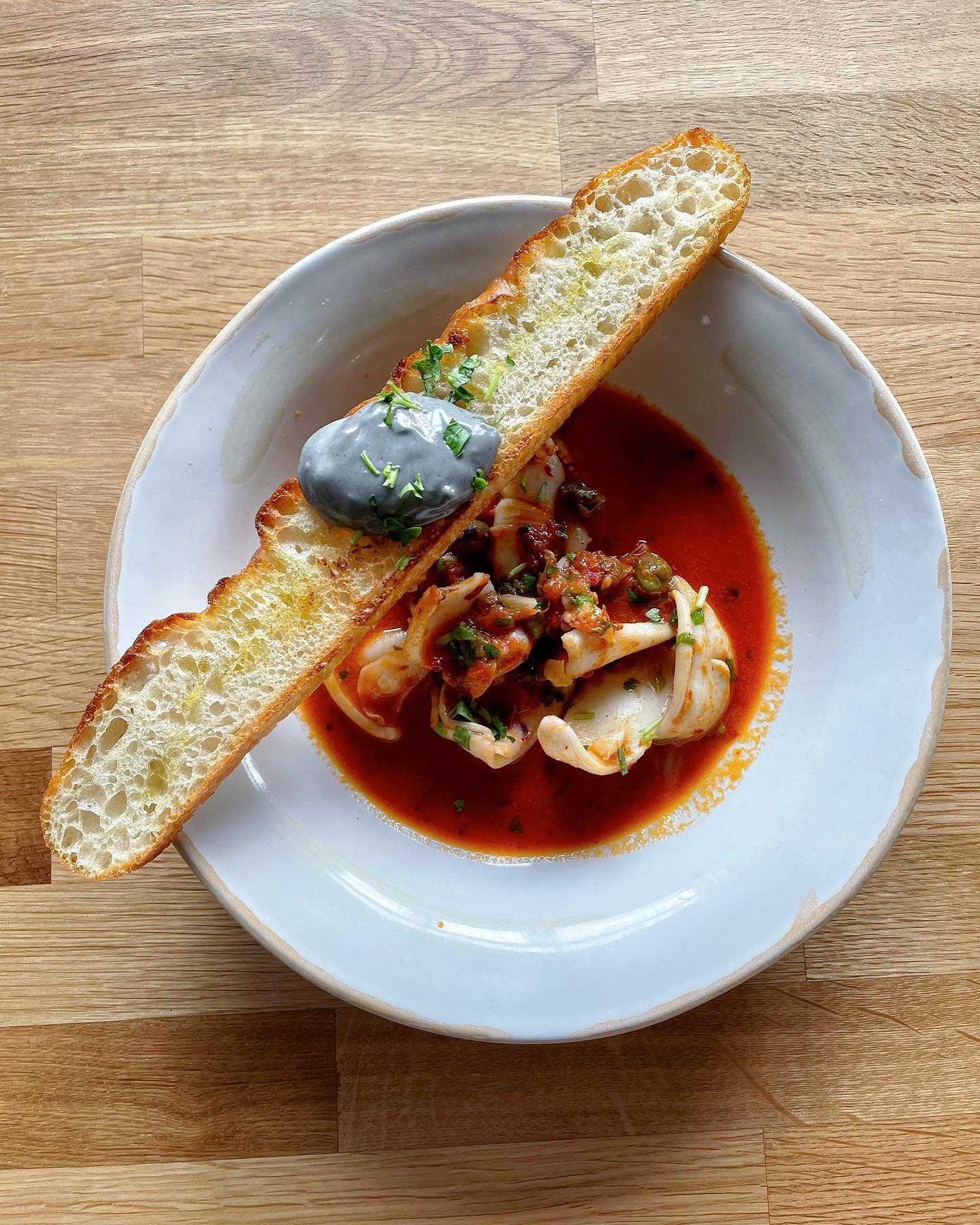 Our Squid had a makeover! We pan fry it with Nduja, butter, white wine, capers, add a touch of tomato sauce and herbs and finish with toasted focaccia and homemade squid ink aioli.
Perfect to start your meal!