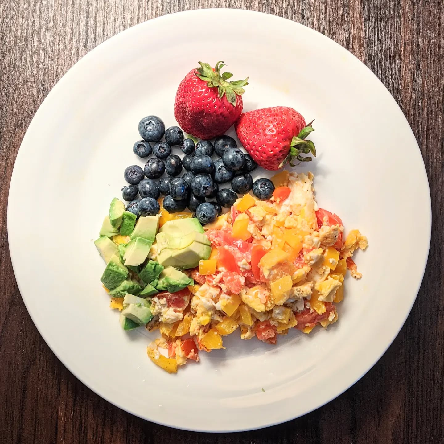 Breakfast doesn't have to take a long time to make it packed with good nutrition.
Take these cheesy veggie eggs with avocado and fresh fruit for example. Good balance of macronutrients to provide satisfaction and it only took about 10 minutes to make!
Here are some tips to speed up the process:
- Use frozen chopped veggies like diced peppers and onions
- Wash your produce the day of grocery shopping so it's ready to grab and eat whenever