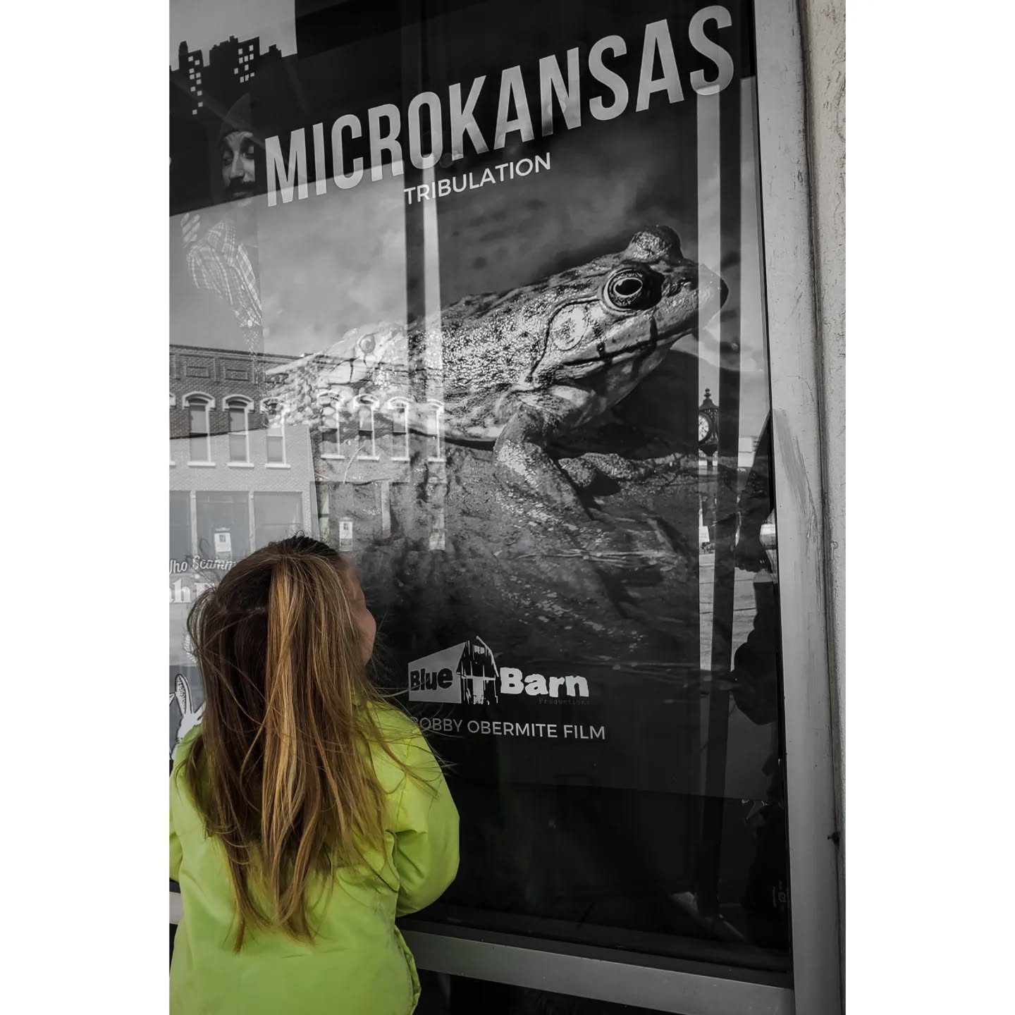 Em admires the poster before going to the screening.