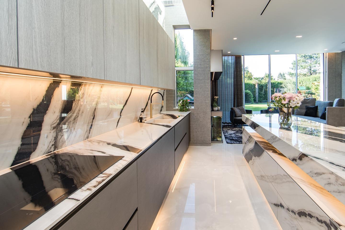 FROM FACTORY TO FINAL
Take a good look at this clip from our factory production of this custom 2800 x 1100 canter lever floating extension that visually defies the laws of gravity.
You can see our top man at Rock & Stone, Schalk Niemand, standing with great confidence and pride on top of the island extension - the sheer fact that this lengthly structure does not subside is an incredibly impressive feat and a significant sight to behold.
A lot of technicalities went into the building of the sub structures and ensuring it’s strength & stability given the floating nature of this design and the 6mm material used to clad the entirety of the visible surfaces.
Schalk has many years experience in the industry conceptualising and building custom designs for clients and projects that push the boundaries of possibility, we are incredibly proud to have him on our team in creating highly skilled masterpieces such as this.
Undertaken in collaboration with Steel & Bone official, much of this project was crafted in-factory at Rock & Stone prior to being shipped off and installed in the UK.
The impressive island feature is composed of 3 varying parts; the top structure, the middle canter lever floating extension and the base below which are all fully cladded in 6mm Panda White with beautiful shadow line details throughout.
Panda White marble by Italgraniti is an elegant rendition that draws inspiration from the luxury stone quarried from the Fujian province in China. It boasts a powerful contrast between a striking white background and deep black veins which flow in varying widths, creating a sensational sense of movement. The high gloss finish on this slab adds an immersive depth and elegance to this stone, perfect for high-end designs and luxury interiors.
Notice the details on the back cooker wall counter which has a fully functional integrated sink built out of stone and the careful eye given to maintaining flow of the veining throughout. Excellence is in the details, love too and we love what we do!
Again we extend our congratulations to all involved in bringing this concept to life, this one is for the books.
@steelandboneofficial @italgraniti