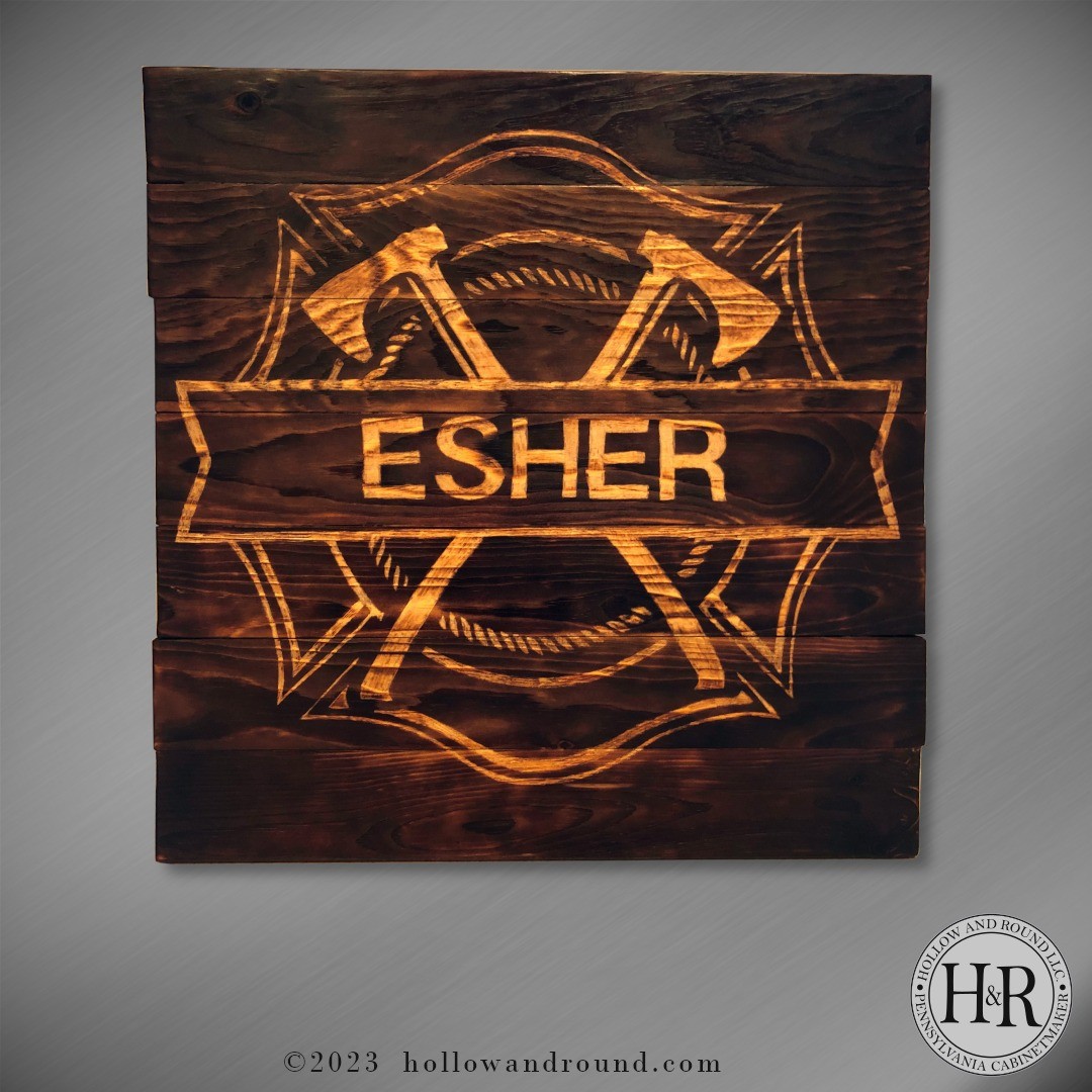 This 24"x24" sign was inspired by a family member who is a volunteer firefighter. Trimmed pine boards set with batons make this rustic form, but the torch burning brings character to the piece. Once burned, the symbols and lettering were manually etched for high-contrast.