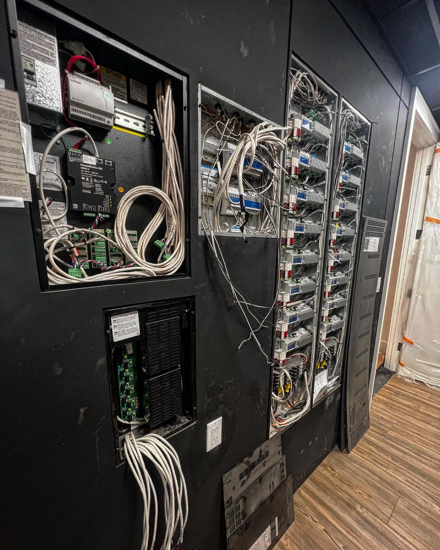 The epicenter of the lighting and shade systems. Love the black painted walls! @lutronelectronics