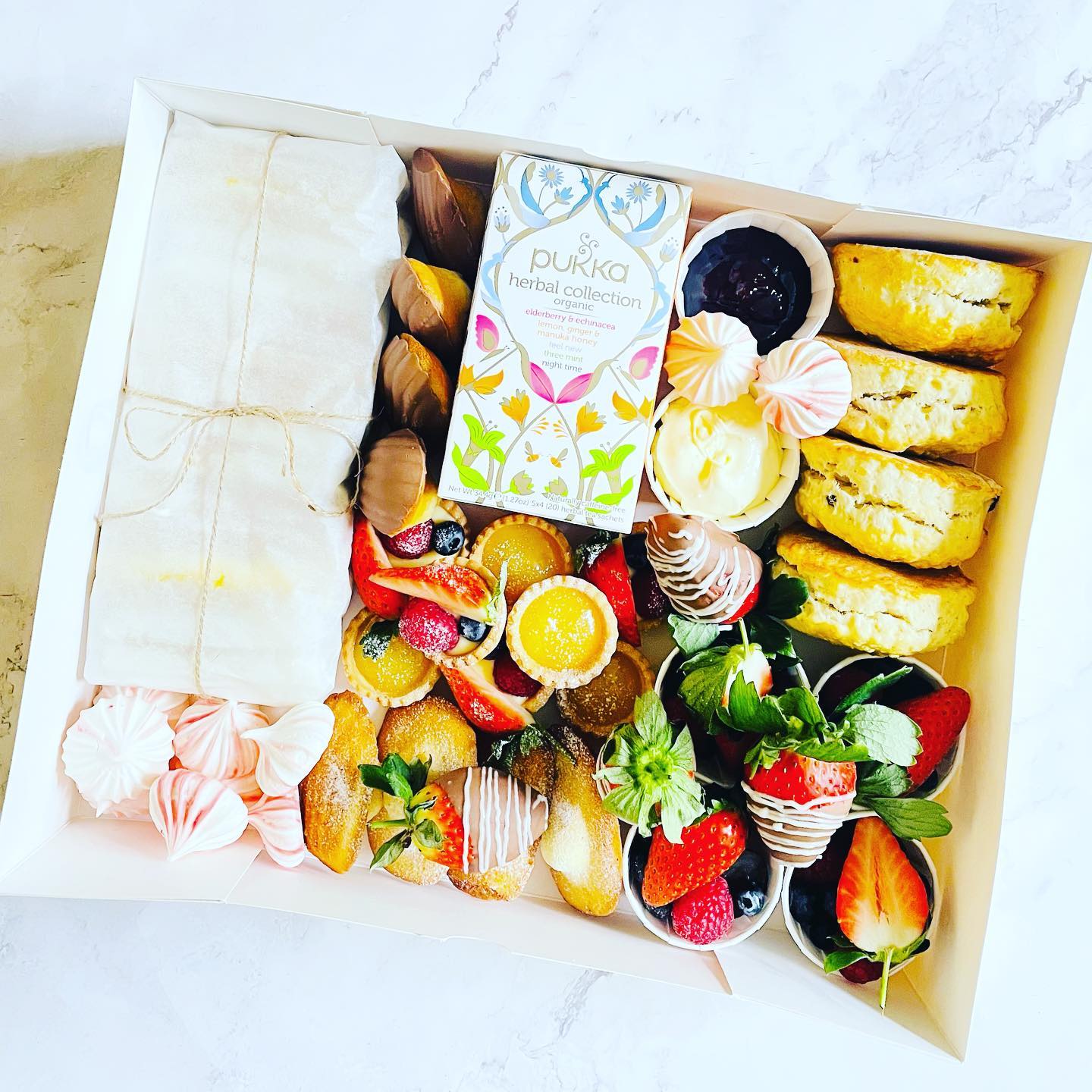 Afternoon Tea Box
This lovely box includes 8 finger sandwiches, scones (plain and raisin) with clotted cream & jam, chocolate madeleines, lemon tartlets, fruit tartlets, meringues kisses, chocolate strawberries, plain madeleines, fresh fruits and a nice tea box
#afternoontea #afternoonteabox #deliveredtoyourdoor #foodgifts #homemade #londonkoshercatering #koshercateringlondon