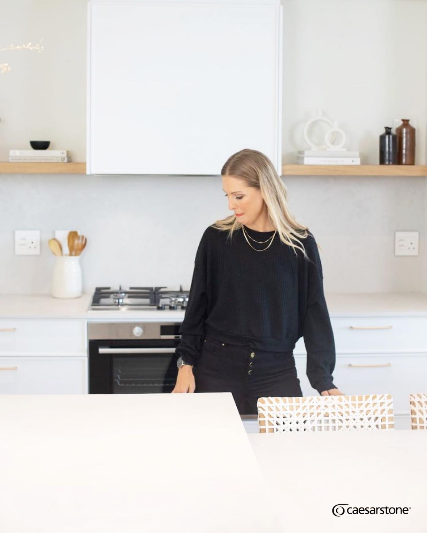 CALMING CLOUDBURST
A neutral kitchen always creates a timeless, natural, welcoming and chic space which exudes feelings of spaciousness, serenity and coziness.
Featuring part 2 of “How to get the Look” by creative director of The Sourcing Lab, Jo Vd Merwe whom we had the pleasure of working with, we introduce you to this heavenly, muted kitchen.
Our team at Rock & Stone installed Ceasrstone Cloudburst Concrete in this kitchen on the island & dining area, cooker wall counter with a full cupboard height splash back and tops with a splash back in the scullery.
Cloudburst Concrete offers a subtle & sophisticated aesthetic with its soft, white on white, tonal cloud like patina delivering a truly unique look. With its textured, low reflective matte surface, this material provides wide design flexibility and is perfect for a minimal, natural and elegant aesthetic.
Paired with soft neutrals on the cabinetry and walls, natural warm elements like the hardwood flooring and oak vignette and beautiful wooden and brass accents, it’s easy to understand how one can create a beautiful, muted and calming space.
For more tips on How to get the Look with Cearsarstone, be sure to check out the video on YouTube for an in depth take on creating a muted interior. https://youtu.be/UQtJTz5X6As
Always a pleasure working with you @thesourcinglab @corekitchens @caesarstonesa
