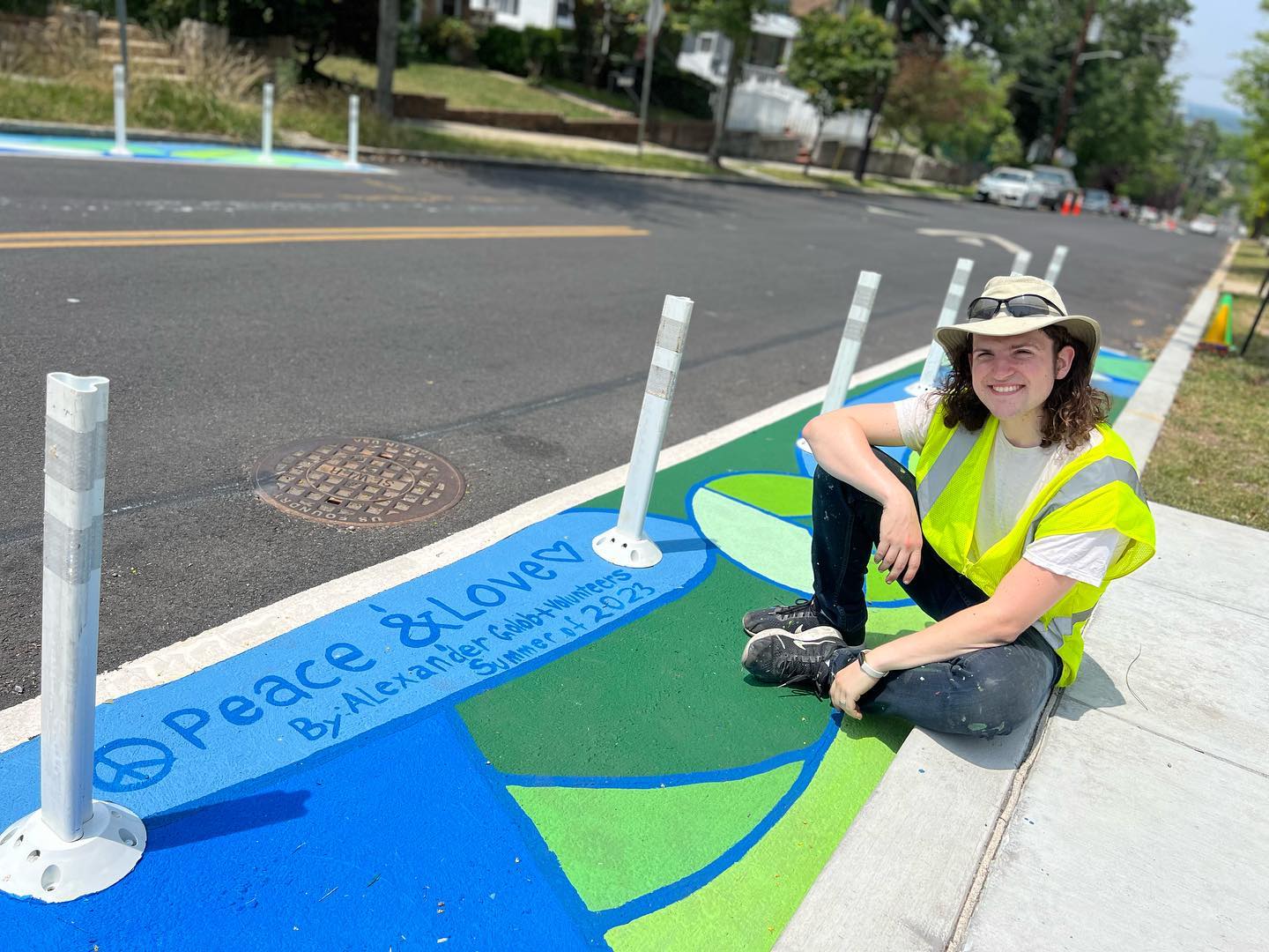 And that’s a wrap! I give you “Peace & Love” DC’s newest mural! 😊 This was commissioned by @thedcarts in collaboration with @ddotdc and @dcpublicschools for the wonderful community at @randlehighlandselementary ! Ground murals and push outs like these are so important, especially near schools, since they make drivers pay more attention to the road and reduce car-inflicted injuries and fatalities. This project took inspiration from the joy, compassion, and nature - we even hosted a workshop with over 20 second graders to have them guide the final design! Despite toxic wild fire smoke, 90+ F days, and more than a few speeding cars, this mural came into being. I wouldn’t have been able to do it without the help of the incredible volunteers who bore the tough conditions to make incredible art together. Thank you! Also a big thank you to all the staff from DC Art (Deirdre and Chelsea @iamchelsea_art ), DDOT (Kelsey), and Randle Highlands (Erica and Chico). Also, a shout out to At-Large DC Councilor @christinahendersondc for sharing the volunteer days. It made a huge difference in this project! Lastly, I want to give the biggest possible shoutout to my fiancé, my love, Sasha @a.little.bird , who spent her two past weekends helping me with then back breaking, sweat making work of creating this mural. It was so much work and I am so deeply appreciative. I love you so much. ❤️
.
.
I have to say, so, so much of my work is e-mails, design, and logistics work, but man oh man, it is the absolute best feeling in the world when it all comes together to create art that contributes to folks’ every day lives. It makes it all worth it.
.
.
.
#colorthecurb #completestreets #dcart #dcmural #peace&love #mural #groundmural #safetymural #publicart #communityart #fineart #murals #dcartist