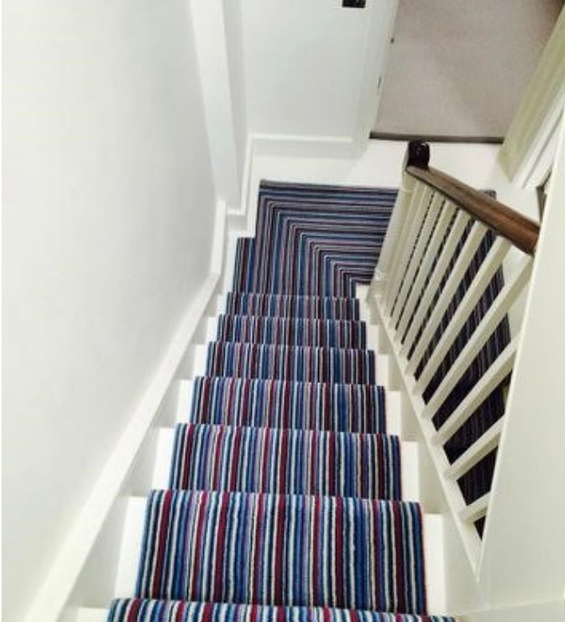 Custom Design Wool Carpet supplied and fitted as a stair runner. A high level of skill and attention to detail was required from our expert fitter in order to keep the stripes flowing in the right direction around the bends of the stairwell in this Knightsbridge home.