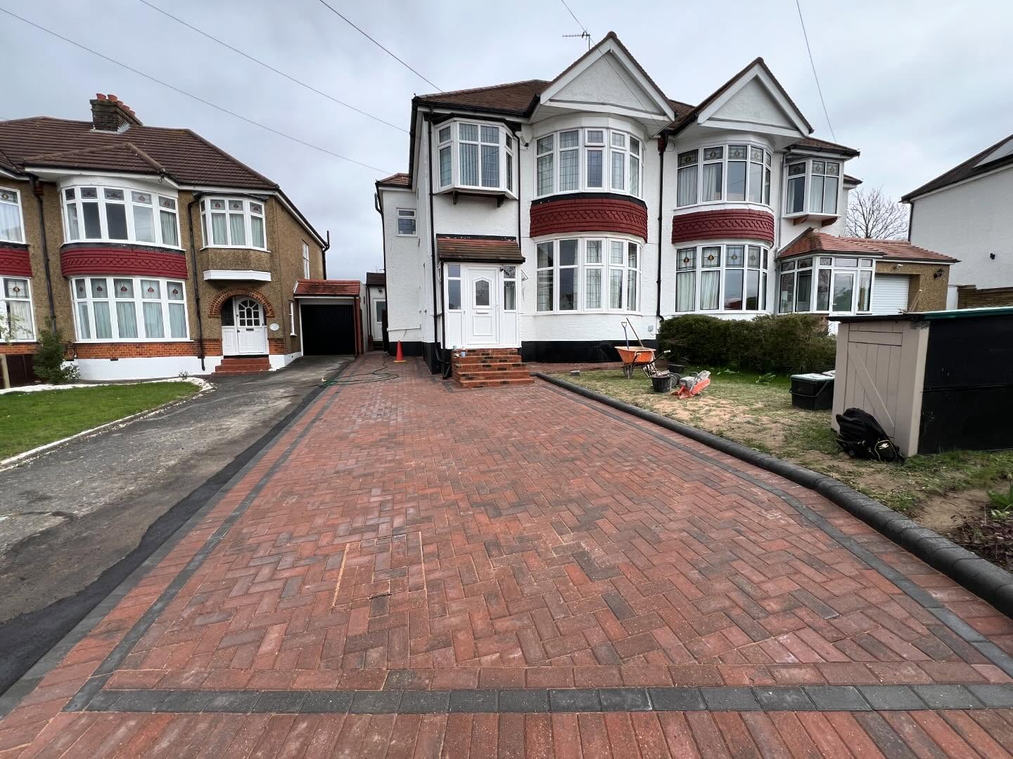 Omega paving brindle with charcoal borders/small and high, curb edgings to match.